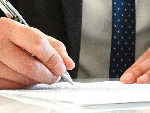man signing a form